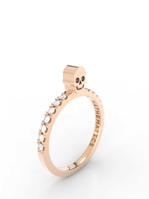 Top view of 14k yellow gold diamond pavé skull slice ring, featuring length and look of slice ring design, white diamonds